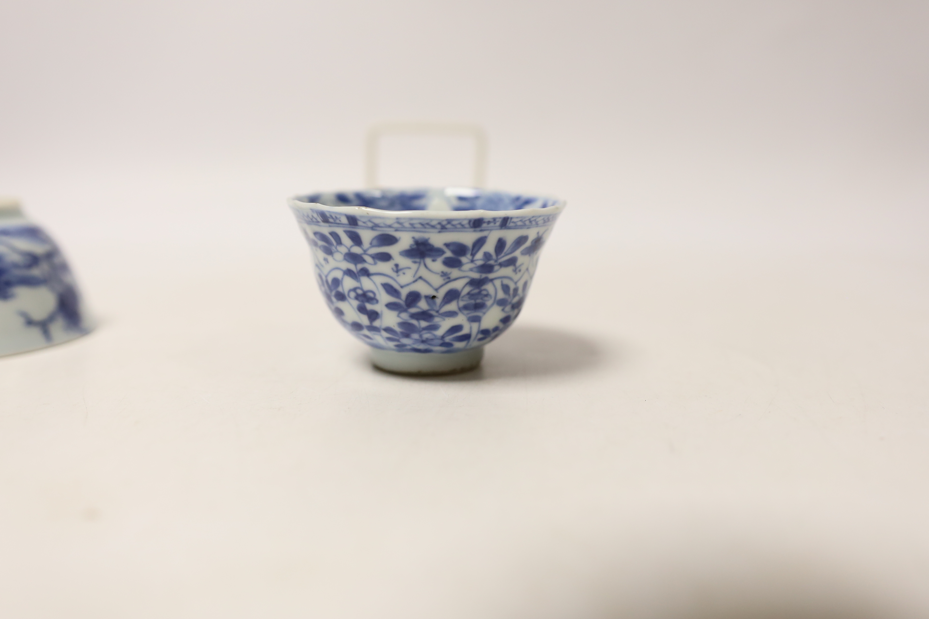 A Chinese Nanking Cargo blue and white saucer and tea bowl, and a Kangxi blue and white tea bowl, largest 11.5cm in diameter